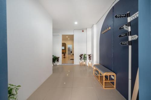 a hallway with a blue wall and a bench at Spacious Haven Chatuchak Market 5BR 10 Sleeps RB1 in Ban Zong Katiam