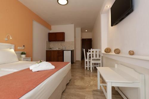 a hotel room with a bed and a kitchen at Hotel Korali in Troulos