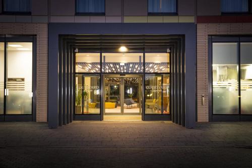 an entrance to a building with glass doors at Courtyard by Marriott Edinburgh West in Edinburgh