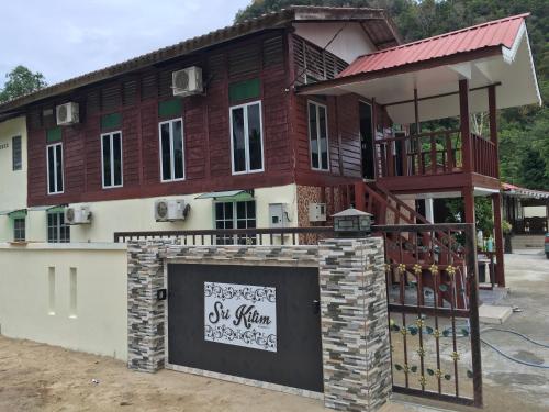 a building with a gate in front of it at Sri Kilim Resthouse and Homestay Langkawi in Kilim