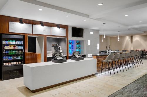a barber shop with chairs and a counter with a machine at Courtyard Milwaukee Downtown in Milwaukee