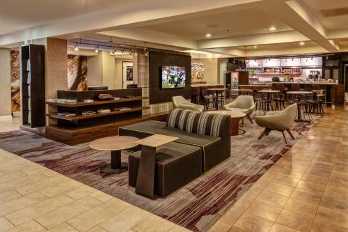 a lobby with couches and tables and a bar at Courtyard Memphis Germantown in Memphis