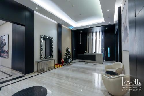 a living room with a christmas tree and a fireplace at Luxury Studio in DAMAC Hills with Premium Amenities in Dubai