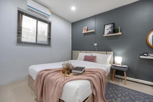 a bedroom with a bed with a blanket on it at Spacious Haven Chatuchak Market 5BR 10 Sleeps RB1 in Ban Zong Katiam