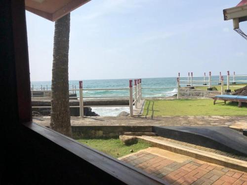 a view of the ocean from a window of a beach at Amara White Villa in Ahungalla