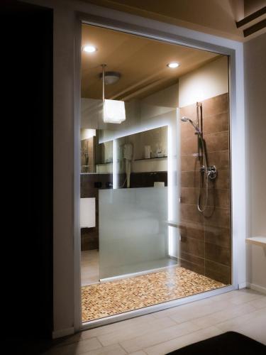 a bathroom with a shower with a glass door at Rimmel Motel in Parma