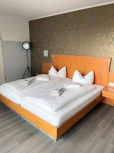 a bedroom with a large bed with white pillows at Studiozimmer-12 in Borkum