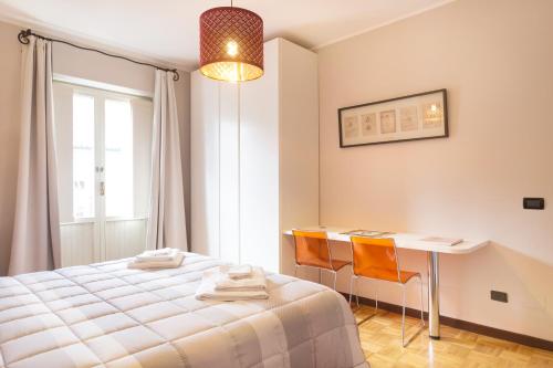 a bedroom with a bed and a table and chairs at A Pochi Passi in Venaria Reale