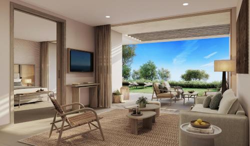 a living room with a couch and a living room with a television at Sani Club in Sani Beach