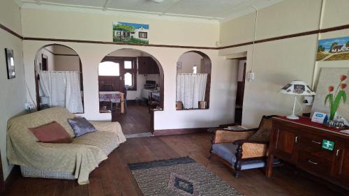 a living room with a couch and a table at Karoo Uitsig Guesthouse in Hanover