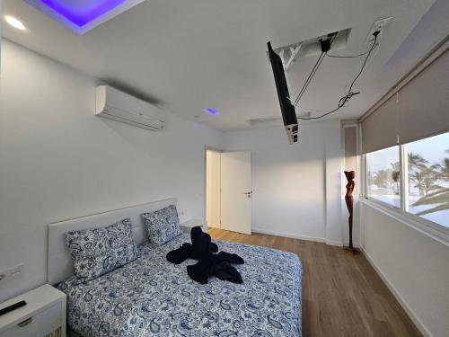 a bedroom with a teddy bear sitting on a bed at Villa Blue Moon in Tías
