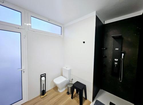 a bathroom with a toilet and a window at Villa Blue Moon in Tías