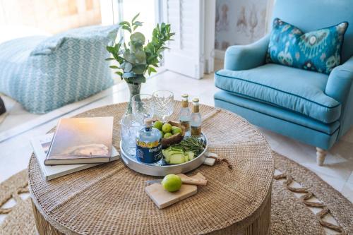 a coffee table with a tray of fruit and drinks on it at Last Word Long Beach in Kommetjie