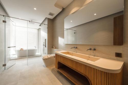 a bathroom with a sink and a tub and a toilet at Nature's Rest Private Pool Villa Rawai in Rawai Beach