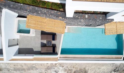 a model of a house with a swimming pool at Santo Pure Oia Suites & Villas in Oia