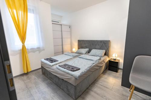 een slaapkamer met een bed en een raam bij Dream Apartman Aliga II in Balatonvilágos