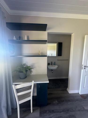 a bathroom with a white desk and a sink at Canyon View Self Catering unit in Groot Brak Rivier