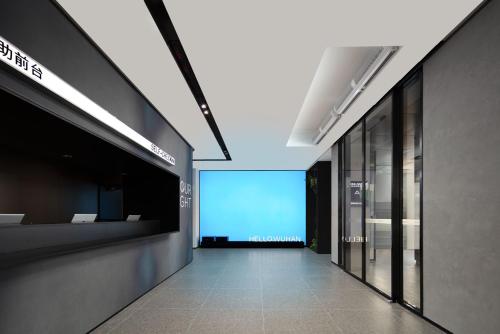 an empty hallway with a blue screen in a building at Atour Hotel Wuhan Hubei University Xudong in Wuhan