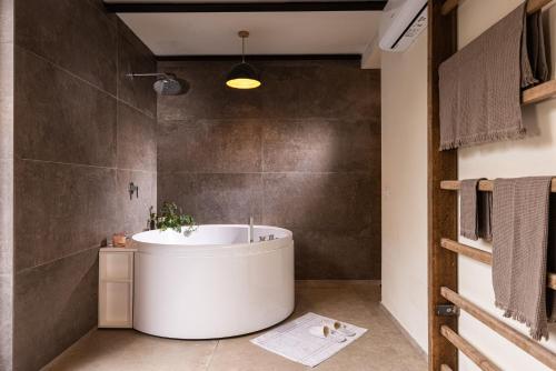 a bathroom with a white tub in a room at Charming apt in Villa with jacuzzi in Milan in Segrate