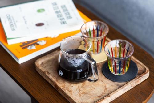 a tray with a cup of coffee and a book at Ningbo Wanda Moments Hotel in Ningbo