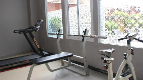 a gym with two exercise bikes next to a window at Merapi Merbabu Hotels Bekasi in Bekasi