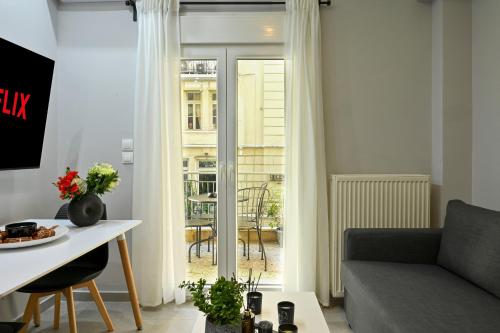 a living room with a couch and a table at Thessaloniki Downtown Luxury Apartment in Thessaloniki