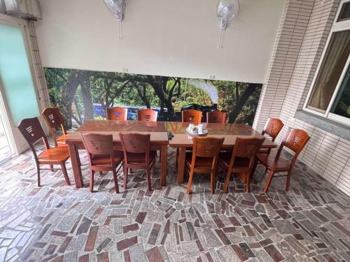 a wooden table and chairs on a patio at Plum Inn 1 in Jiji
