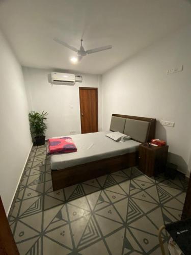 a bedroom with a large bed in a room at Half Orangee Party Stay with Free Swimming Pool, Free Game Room, Free Parking Next to Vagator Beach-Near to Chapora Fort-Near to Hill Top -Best for Couples-Backpackers, Long stays, Coworking, Day-use with Game zone and summer vacation!! in Vagator