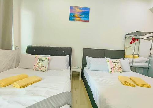 two beds sitting next to each other in a room at Airly Cybersquare Ensuite with Pool View #CS7 in Cyberjaya