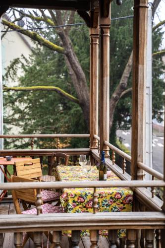 a gazebo with a table and a glass of wine at Domaine Bohème I art de vivre in Guebwiller