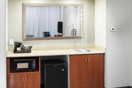 a kitchen with a sink and a microwave at Courtyard by Marriott Birmingham Trussville in Trussville