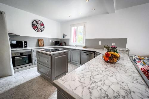 a kitchen with a counter with a bowl of fruit on it at Shirley - Villa for 10 Pool Terrace - by TGB in Cuttoli-Corticchiato