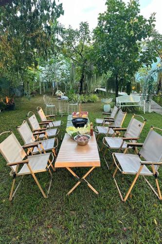 a group of chairs and a table with a bowl on it at Peang Tara Cafe & Resort in Nong Khai