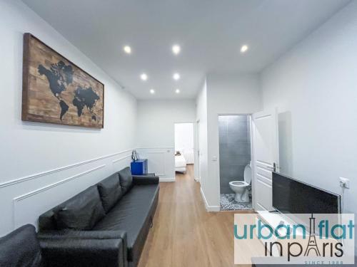 un salon avec un canapé et une télévision à écran plat dans l'établissement 35 - Urban Montmartre, à Paris