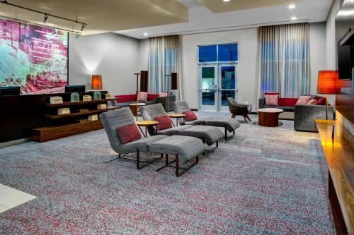 a living room with couches chairs and a television at Courtyard by Marriott Nashville Mount Juliet in Mount Juliet