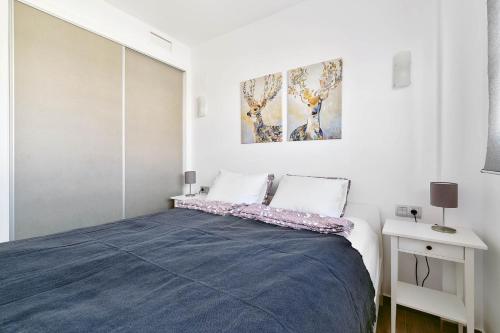 una camera da letto con un letto con una coperta blu di Villa Amalia II - Heated Pool, Sauna & Jacuzzi a Torrevieja