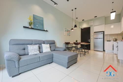 a living room with a couch and a kitchen at Astoria Ampang By Grabstay in Kuala Lumpur