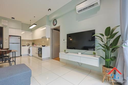 a living room with a large flat screen tv on a wall at Astoria Ampang By Grabstay in Kuala Lumpur