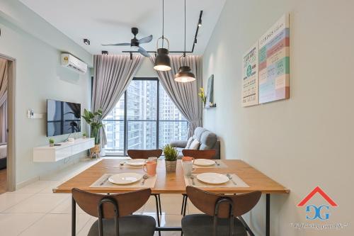 a dining room with a wooden table and chairs at Astoria Ampang By Grabstay in Kuala Lumpur