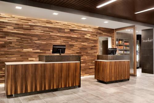 a lobby of a hotel with a stone wall at Courtyard by Marriott St Paul Woodbury in Woodbury