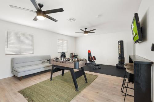 a living room with a game table and a couch at Sunfit Dreams 2BD BBQ Pool & Fitness in Mesa