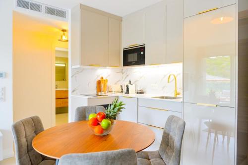 - une cuisine avec une table en bois et un bol de fruits dans l'établissement Livia - Agosta beach by foot Terrace - by TGB, à Albitreccia