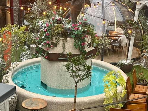 a small pool with flowers and plants in it at The Lanes Townhouse Retreat in Brighton & Hove