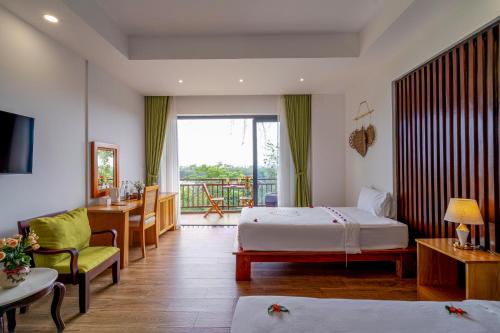 a hotel room with a bed and a balcony at Palm Riverside Boutique in Hoi An
