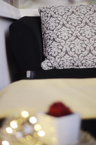 a black and white pillow sitting on a couch at Apartments Rubis in Stožice