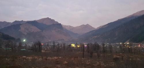 a view of a city with mountains in the background at Ekaant Stays - Manali in Manāli