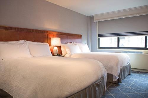 a hotel room with two beds and a window at Courtyard by Marriott New York Manhattan/ Fifth Avenue in New York