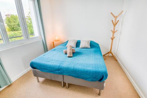 - une chambre dotée d'un lit bleu avec deux animaux rembourrés dans l'établissement Paisible appartement Central & lumineux par Groom, à Lorient