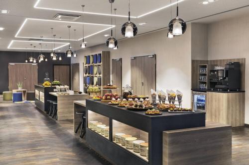 a buffet line with food on display in a restaurant at Courtyard by Marriott Hamburg City in Hamburg