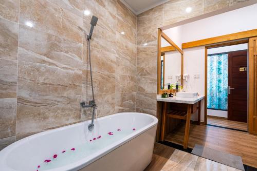 a bathroom with a tub and a sink at Palm Riverside Boutique in Hoi An